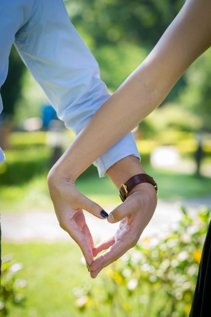 couple making heart with their hands