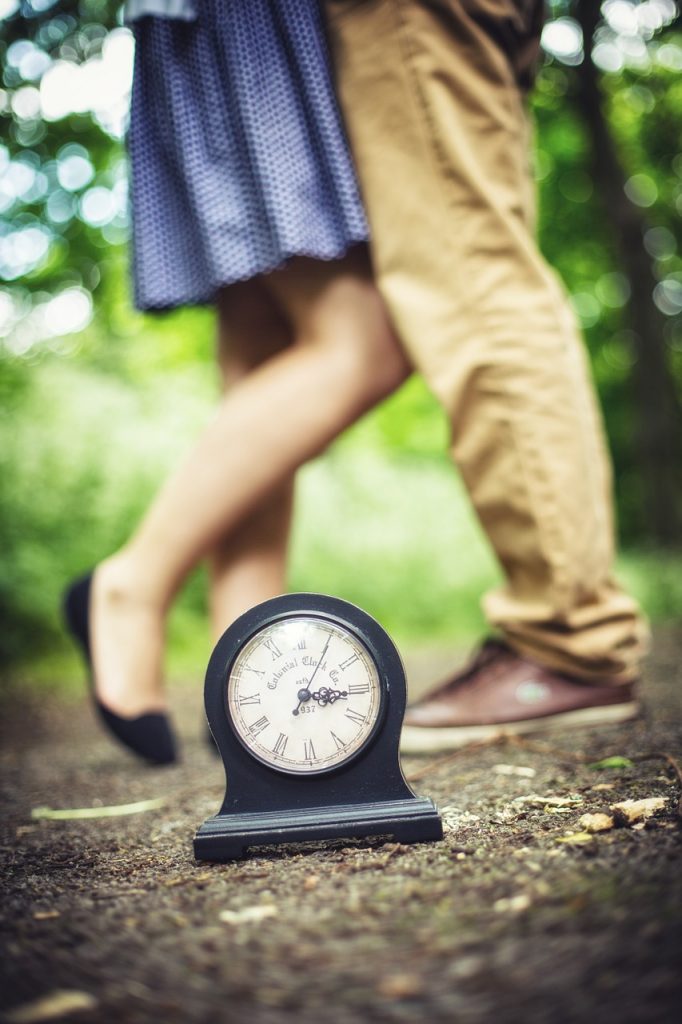 teens in front of a clock