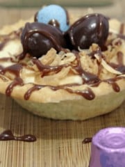 simple tart shells filled with pudding, topped with toasted coconut and decorated with egg shaped candy 