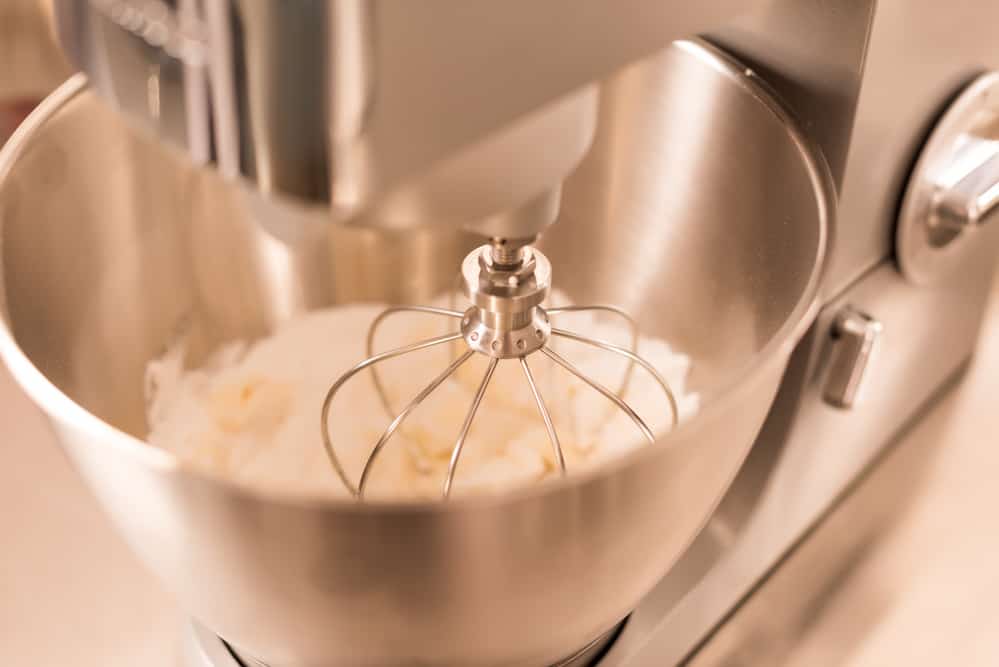 homemade whipped cream in the bowl of a stainless steel mixer