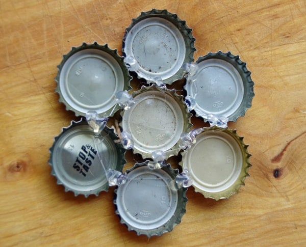 used bottle caps glued together in the shape of a flower