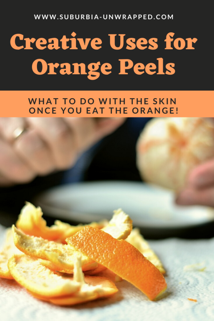 Woman peeling orange and pile of orange peels on napkin