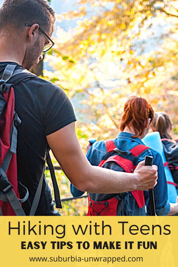 family hiking together with backpacks and hiking poles