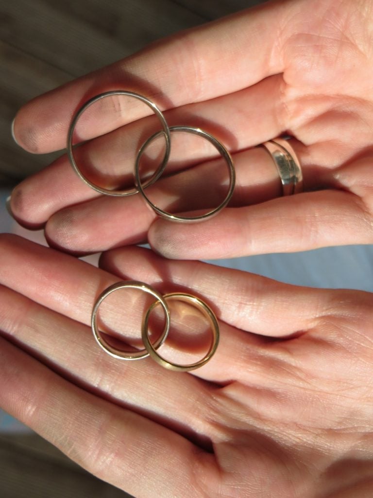 gold rings that need cleaning in a person's hands