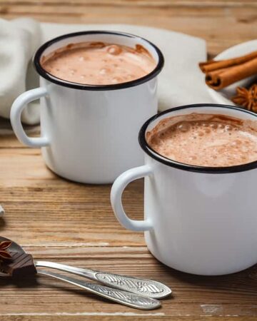 homemade hot chocolate and spices on a wooden table