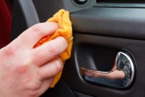 someone Cleaning the car interior with polishing cloth