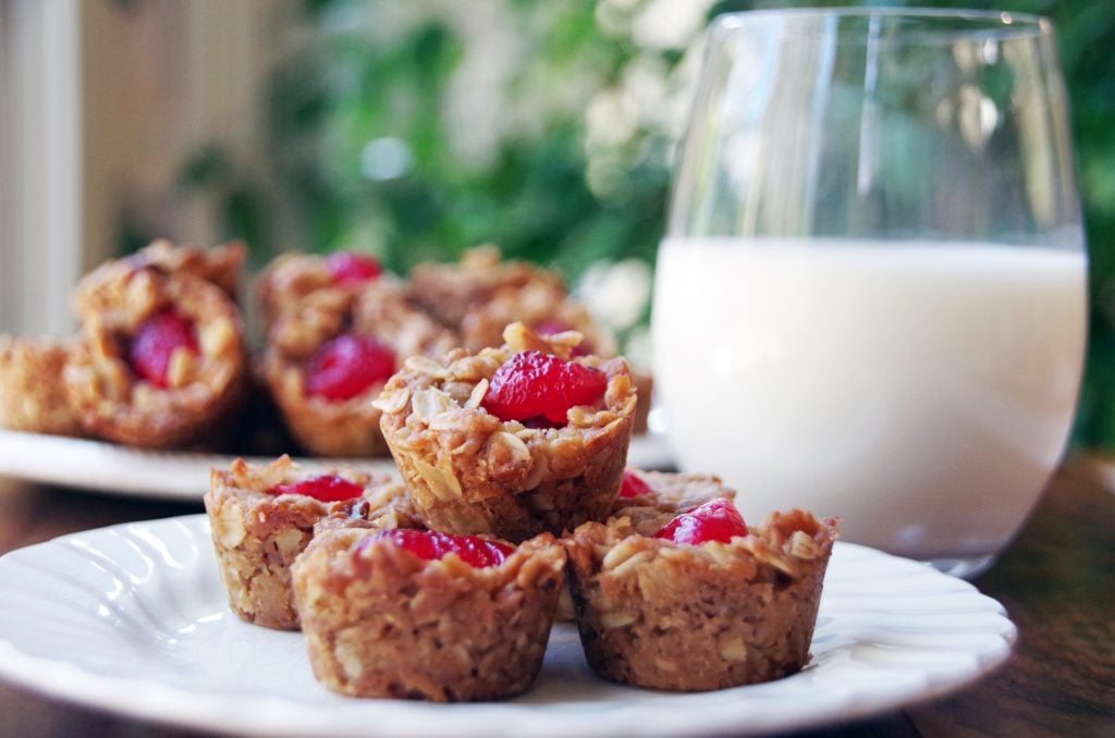 Honey Macaroonies on a white plate with a glass of milk