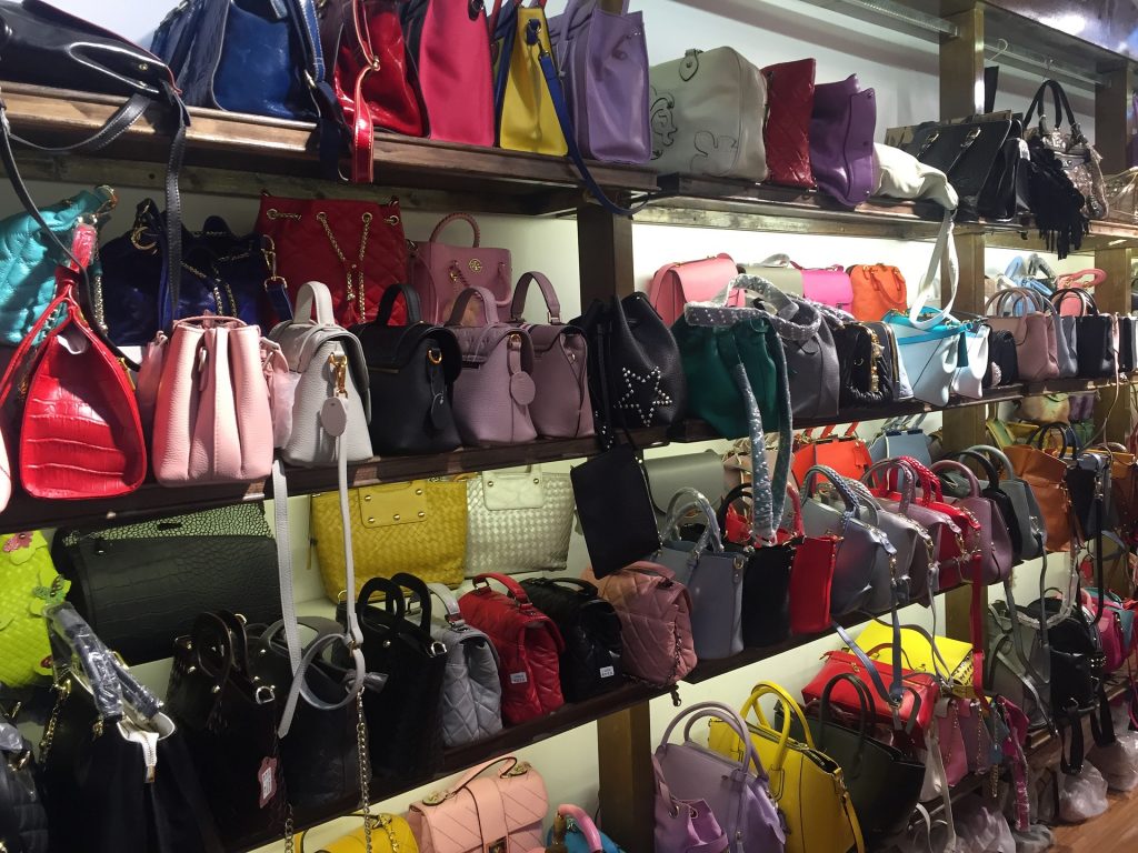 thrift store shelves filled with purses