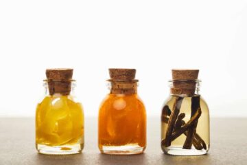 Lemon, orange and vanilla extracts in glass bottles