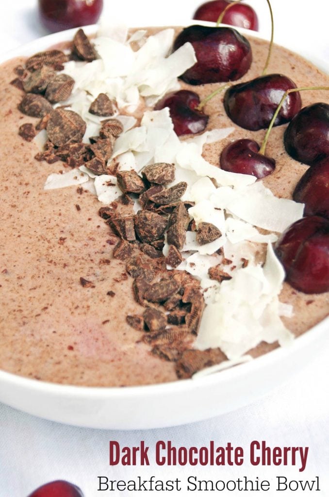 cherry smoothie bowl with chocolate and coconut in white bowl