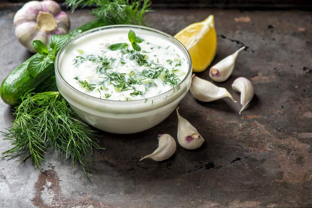 Tzatziki sauce ingredients cucumber garlic Healthy food backgrou