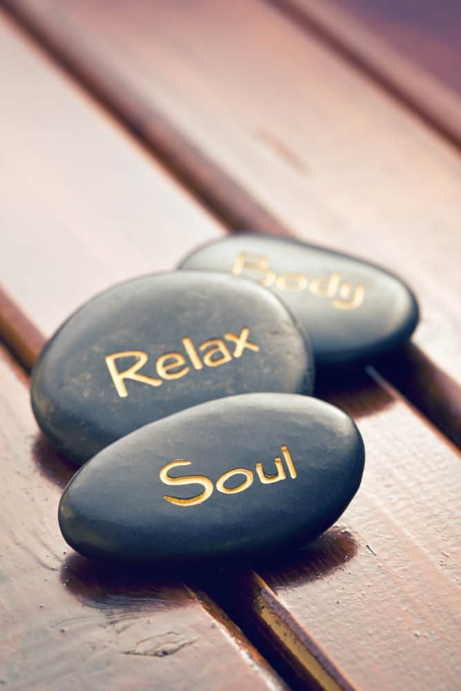 meditation spa stones on wooden background