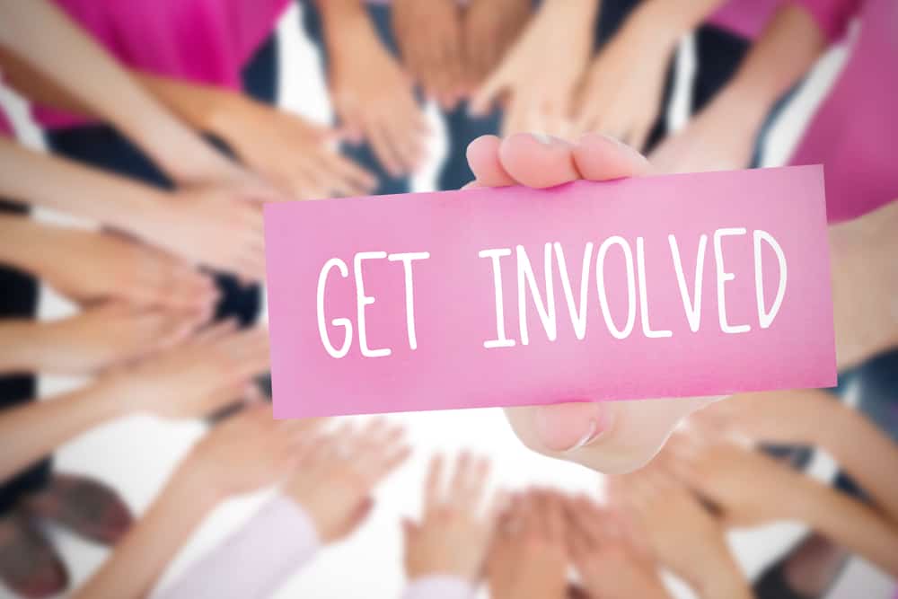 The word get involved and young woman holding blank card against oktoberfest graphics