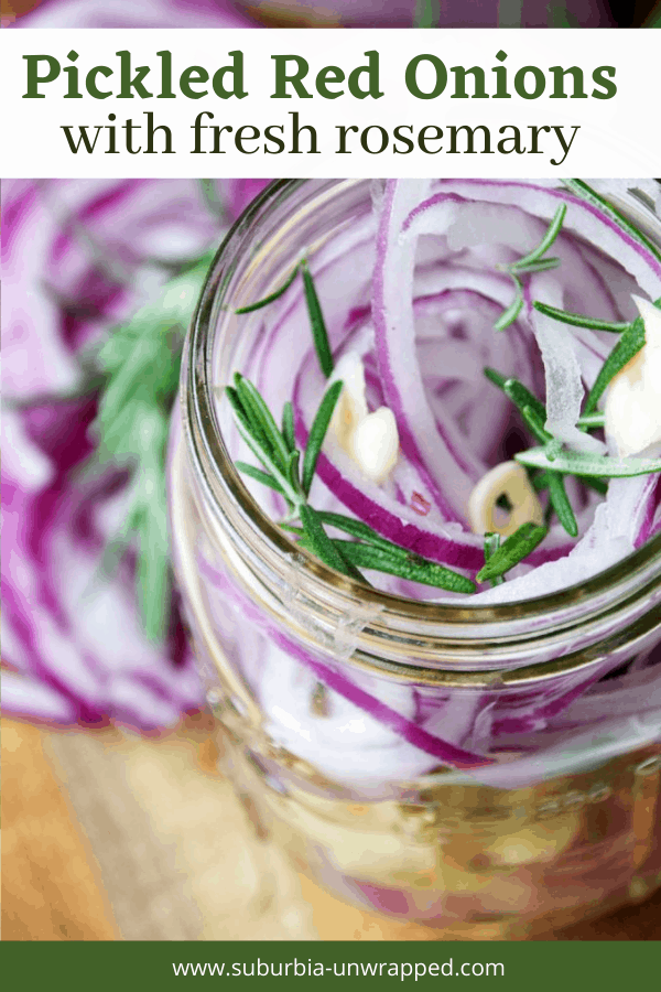 Jar of pickled red onions with garlic and fresh rosemary