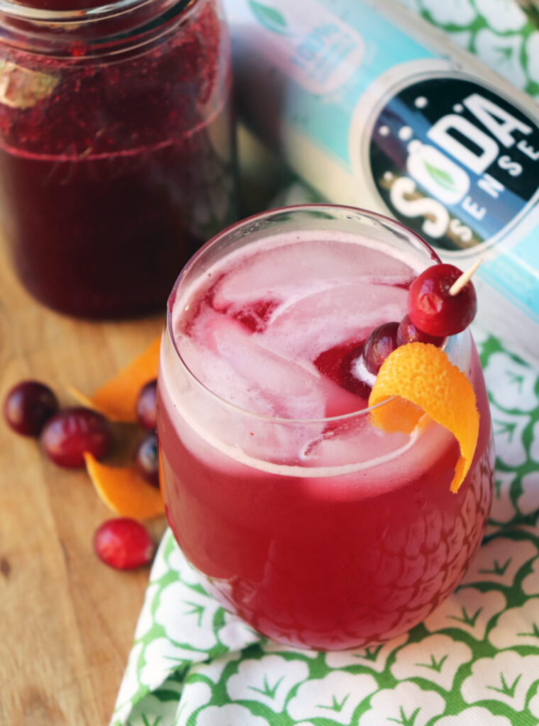 Cranberry soda with soda sense canister in background