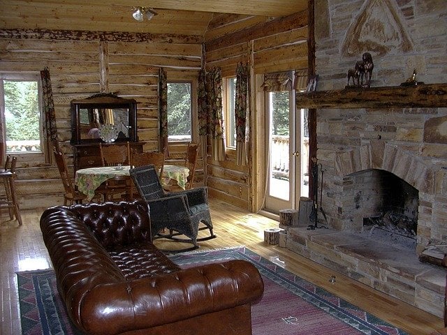 fireplace and leather couch in rustic living room