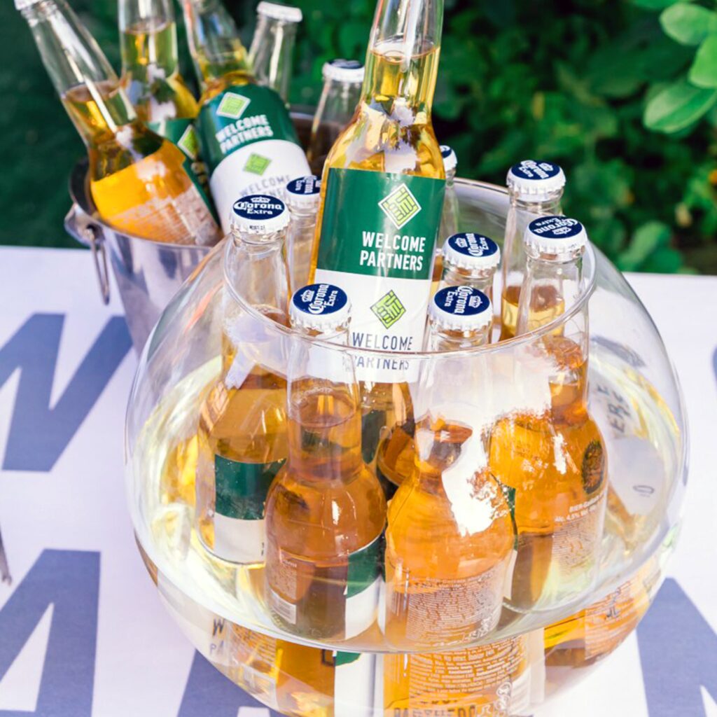 large glass bowl of bottles of beer outside 