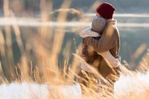 back view of young couple hugging in winter