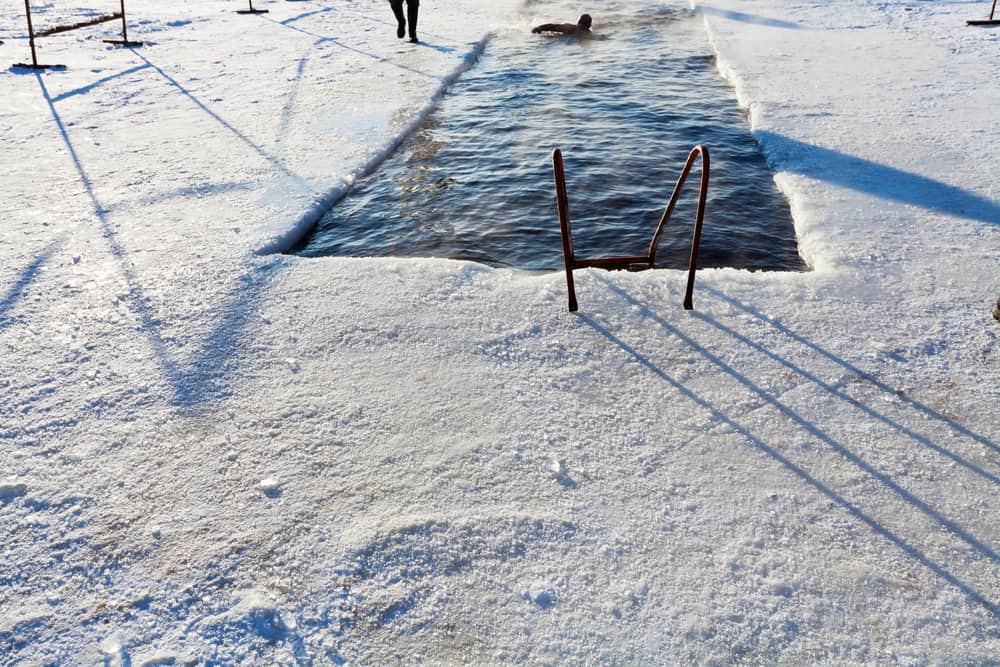 winter swimming in river ice hole in frost winter day in Moscow, Russia