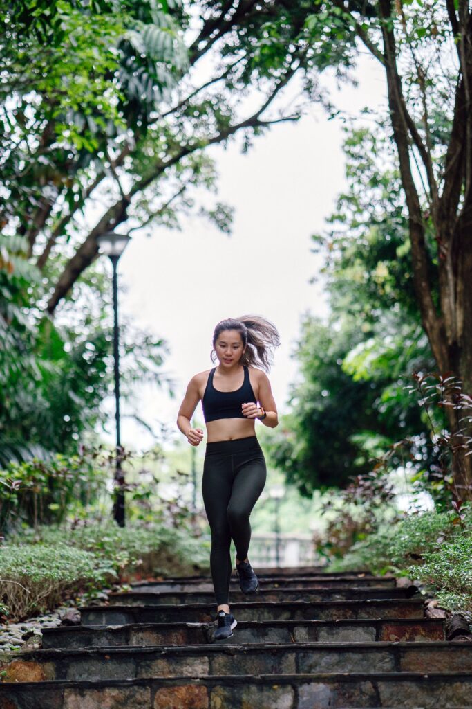 woman running down stairs as part of an outdoor workout plan