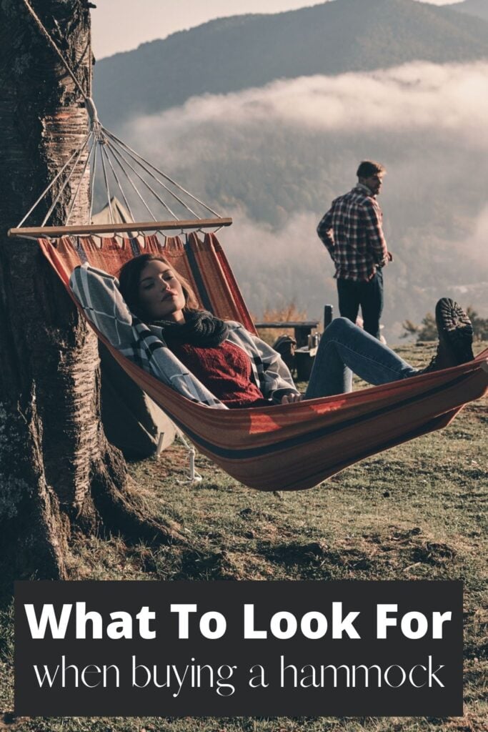 woman in woods in hammock with text overlay what to look for when buying a hammock 