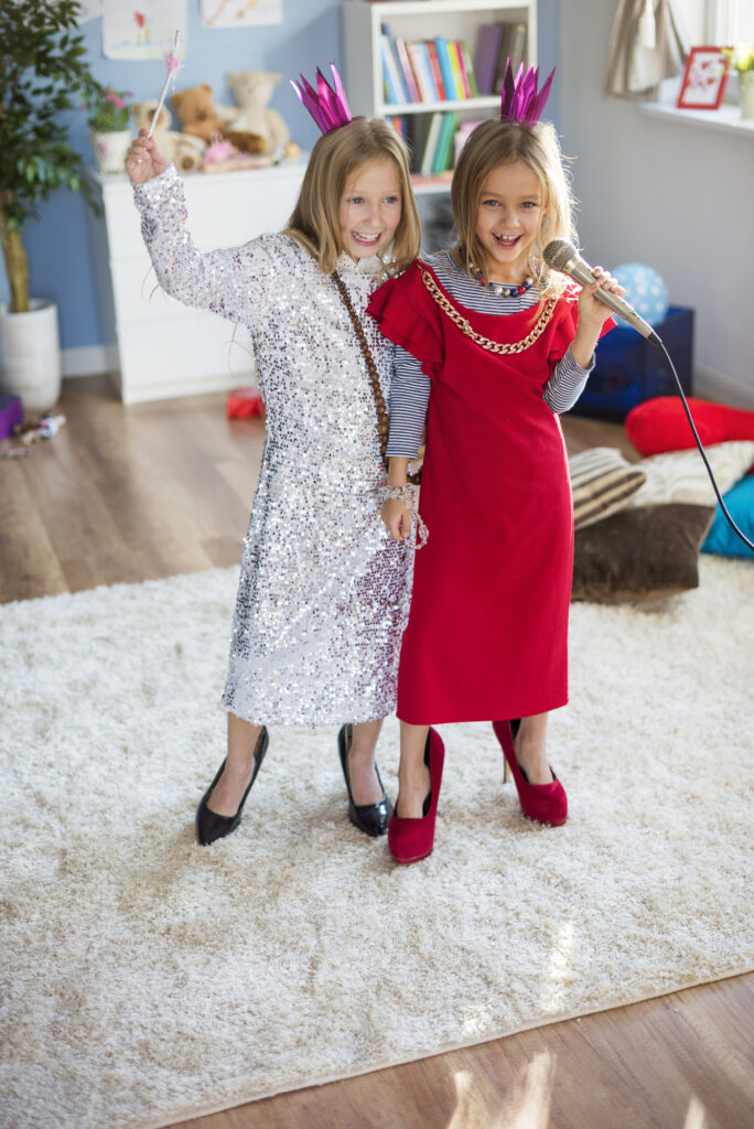 children playing dress up in old clothing