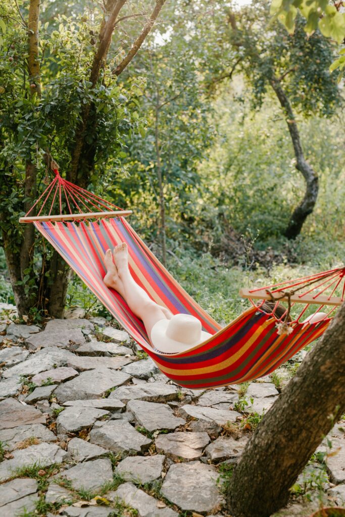 person resting in hammock in garden